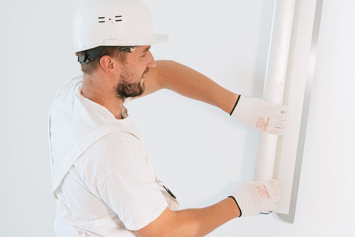 Tradesman hanging drywall on a job site